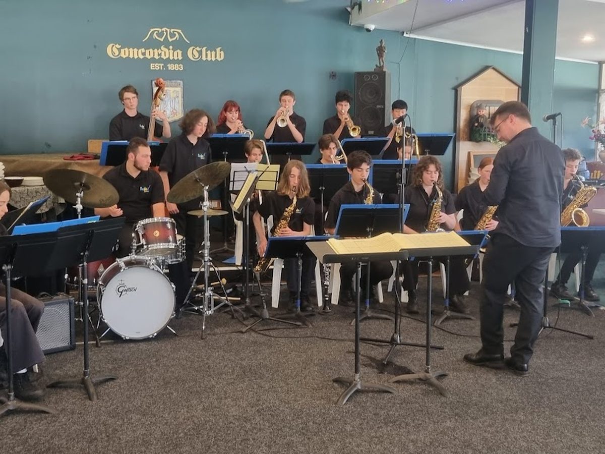 A live band performing under the Concordia Club Est. 1883 sign